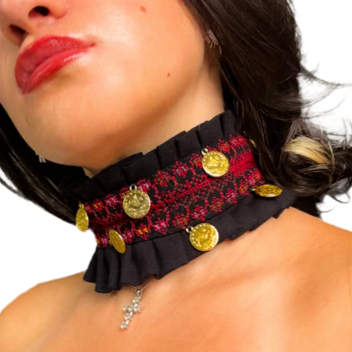 Close-up of a woman wearing a decorative tatreez choker with gold coins and ruffles.