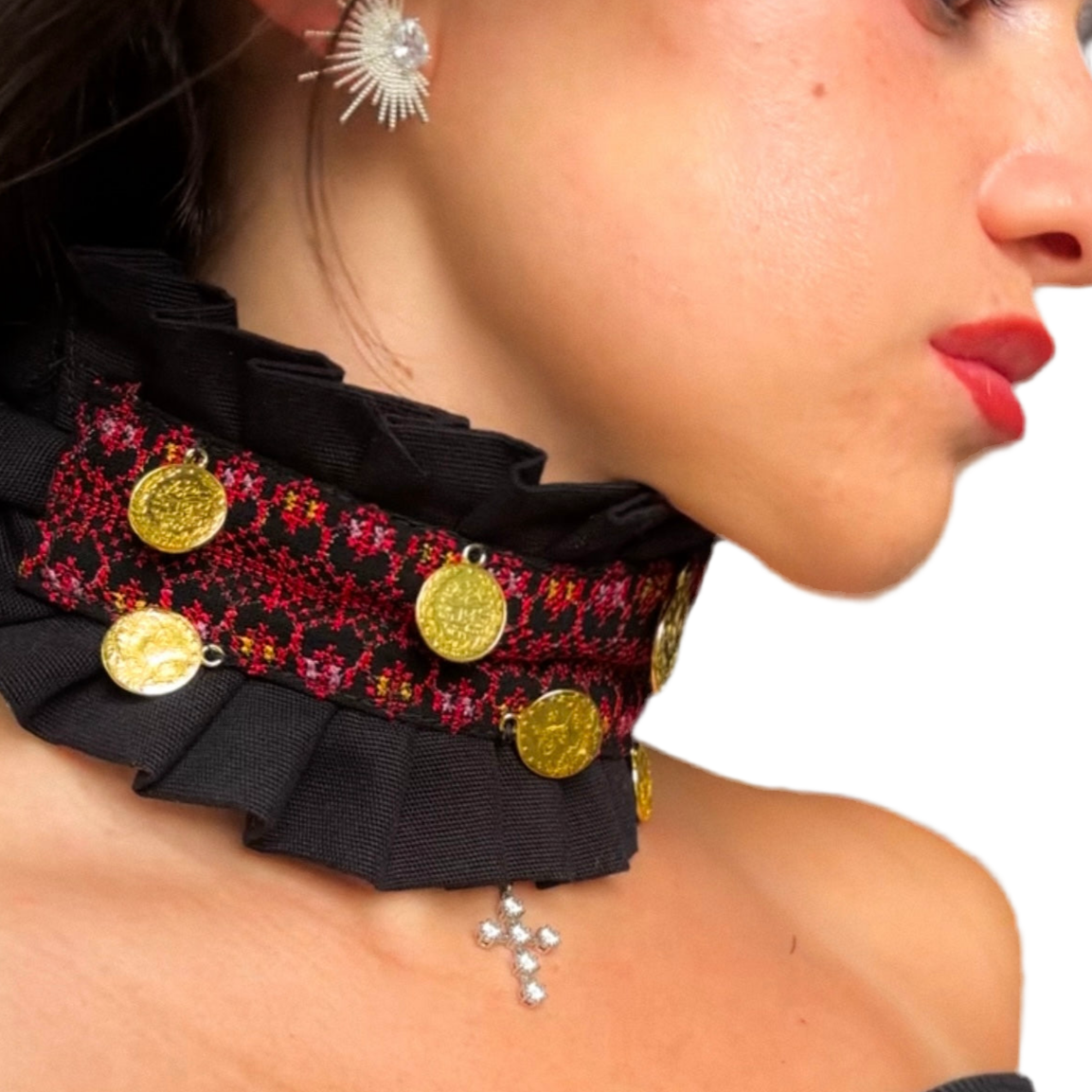 Close-up of a woman wearing a decorative tatreez choker with gold coins and ruffles.